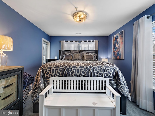 bedroom featuring carpet floors and visible vents