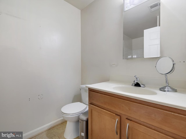 bathroom featuring toilet, baseboards, visible vents, and vanity