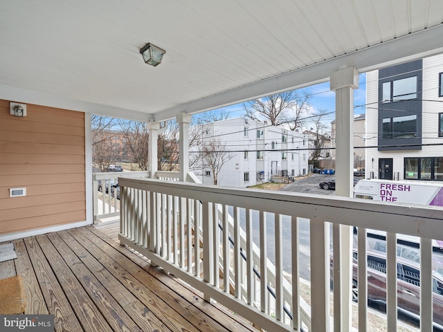 wooden terrace featuring a residential view