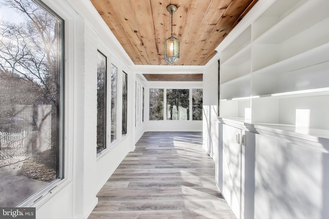 hallway featuring wooden ceiling and wood finished floors