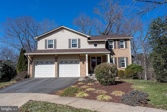 traditional home with a garage, brick siding, driveway, and a shingled roof