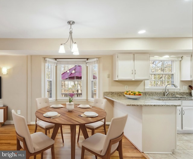 dining area featuring recessed lighting, baseboards, and a chandelier