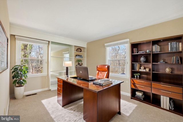 home office featuring visible vents, baseboards, and light colored carpet