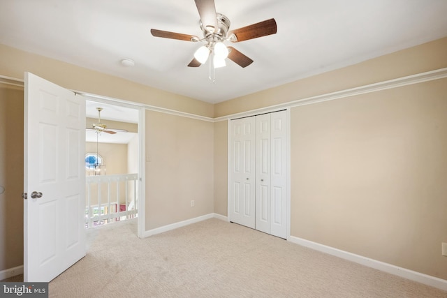 unfurnished bedroom featuring a closet, a ceiling fan, baseboards, and carpet floors