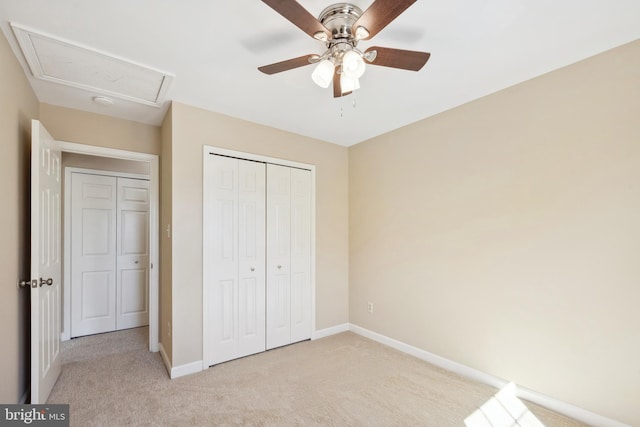 unfurnished bedroom featuring a closet, carpet flooring, ceiling fan, and baseboards