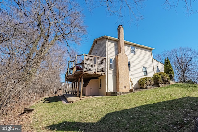 view of home's exterior featuring a deck, a yard, and a chimney