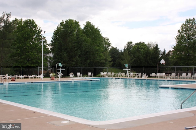 community pool featuring a patio area and fence