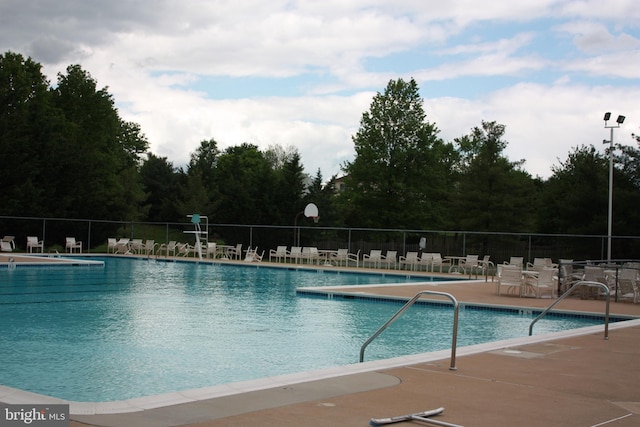 community pool featuring a patio and fence