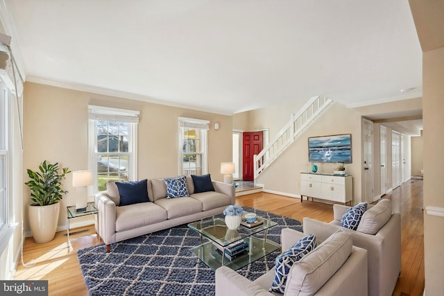 living room with stairway, visible vents, wood finished floors, and ornamental molding