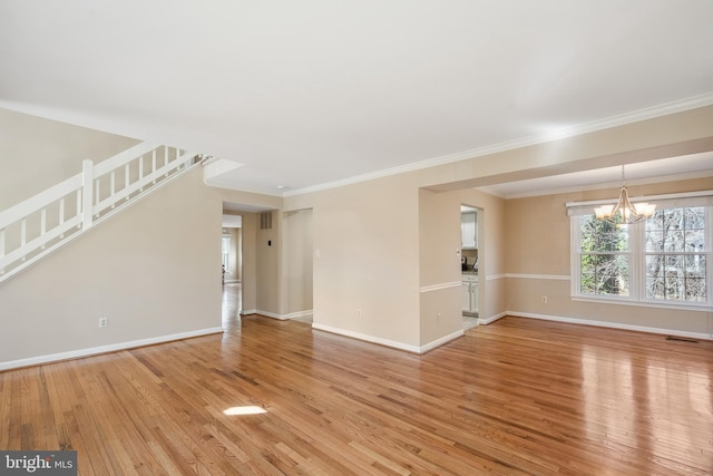 unfurnished living room with stairway, baseboards, crown molding, light wood-type flooring, and a chandelier