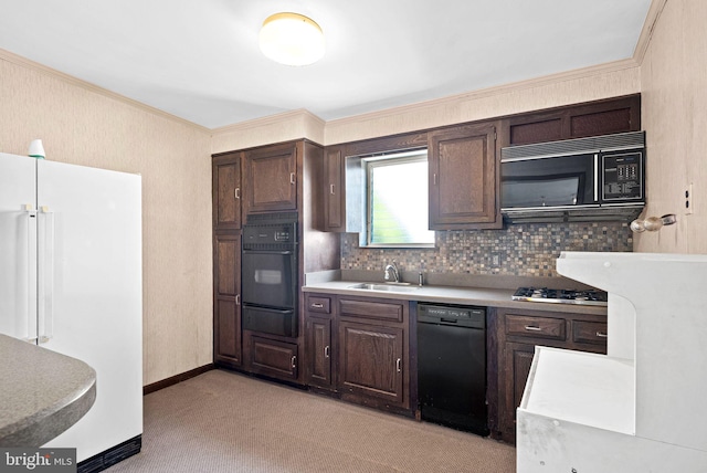 kitchen with a warming drawer, black appliances, a sink, and dark brown cabinets