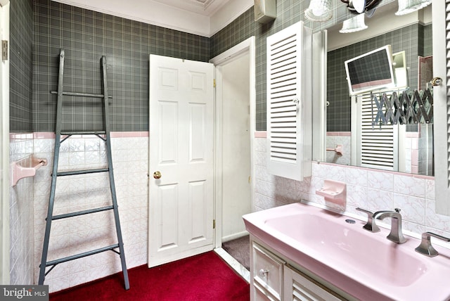 bathroom featuring tile walls, vanity, and ornamental molding