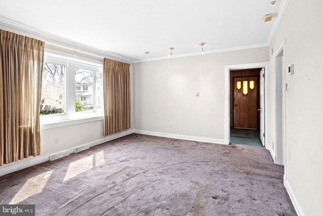 unfurnished room with baseboards, carpet, and crown molding