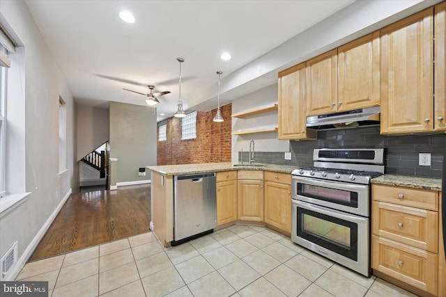 kitchen featuring a sink, under cabinet range hood, light brown cabinetry, stainless steel appliances, and open shelves