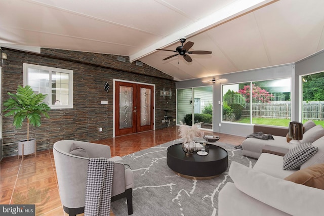 living room with lofted ceiling with beams, ceiling fan, and french doors