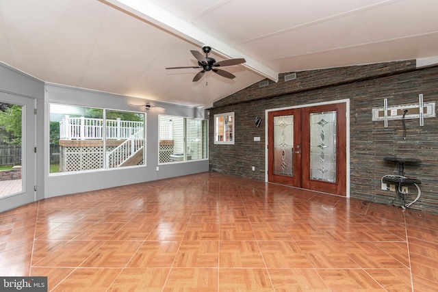 unfurnished living room with french doors, vaulted ceiling with beams, and ceiling fan