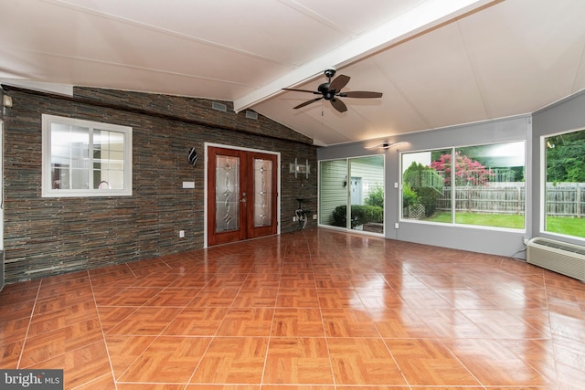 unfurnished sunroom featuring vaulted ceiling with beams, a wall unit AC, a ceiling fan, and french doors