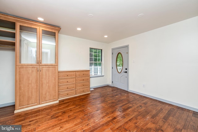 foyer entrance featuring dark wood-style flooring, recessed lighting, and baseboards