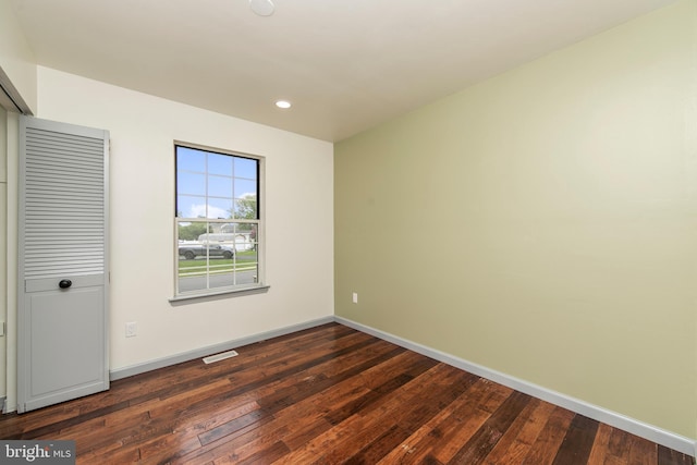 unfurnished bedroom with dark wood-type flooring, recessed lighting, and baseboards