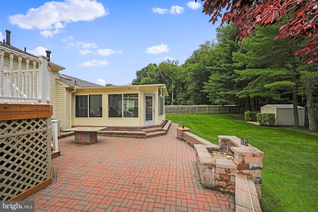 view of patio / terrace with an outbuilding, fence, a storage shed, and entry steps