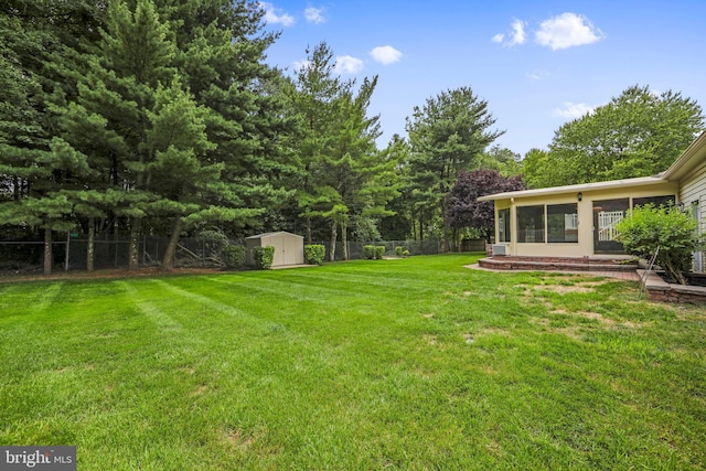 view of yard featuring a storage shed, an outbuilding, and a fenced backyard