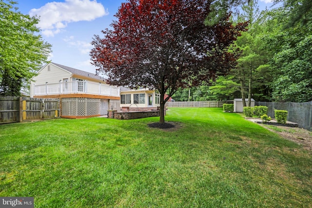 view of yard featuring a fenced backyard and a sunroom