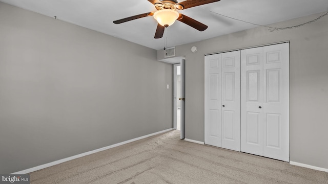 unfurnished bedroom featuring visible vents, a ceiling fan, a closet, carpet flooring, and baseboards