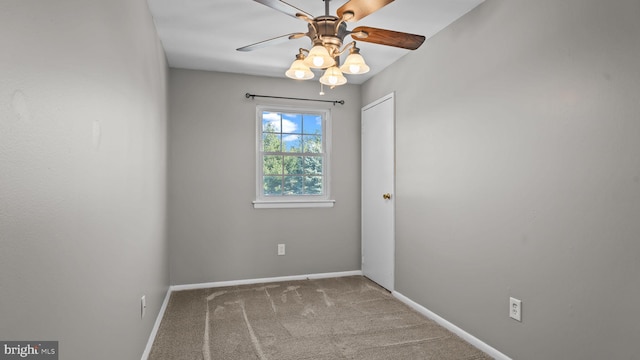 unfurnished room featuring baseboards, a ceiling fan, and carpet