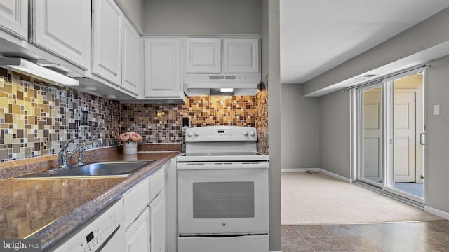 kitchen featuring white appliances, backsplash, under cabinet range hood, and a sink