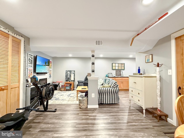 workout room with recessed lighting, visible vents, baseboards, and wood finished floors