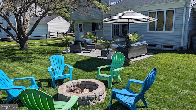 view of yard featuring an outdoor living space with a fire pit and a patio