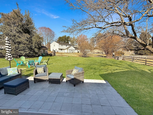 view of patio with an outdoor living space and a fenced backyard