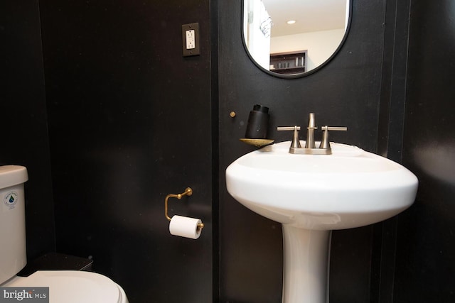 bathroom featuring toilet and a sink