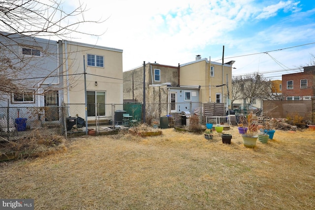 rear view of house with fence and stucco siding