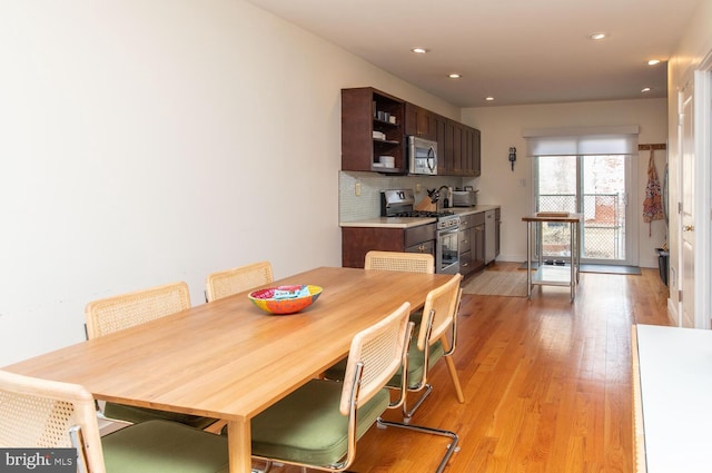 dining room featuring light wood-style floors and recessed lighting