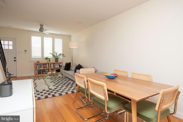 dining space with light wood-type flooring and ceiling fan