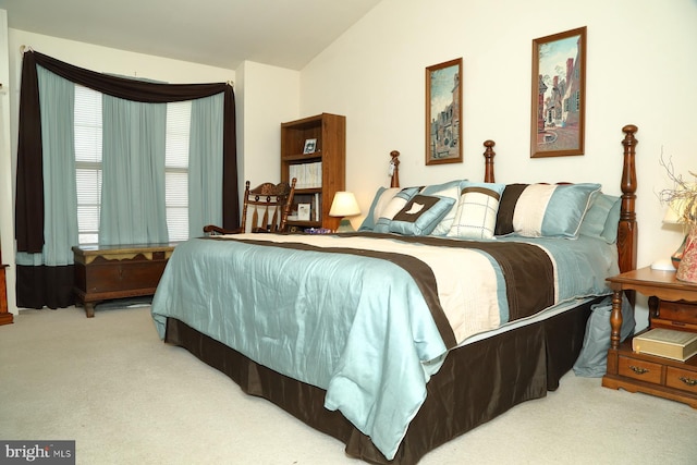 carpeted bedroom with lofted ceiling