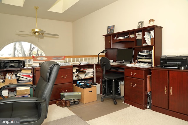 home office with a skylight, carpet flooring, and a ceiling fan