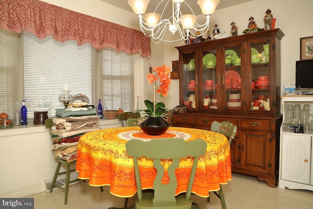 dining space with an inviting chandelier and light floors