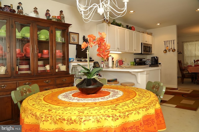 dining area featuring light floors, a chandelier, and recessed lighting