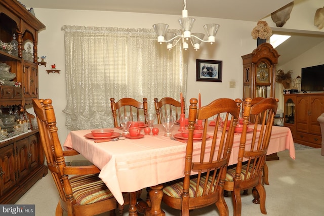 dining room with a chandelier and carpet