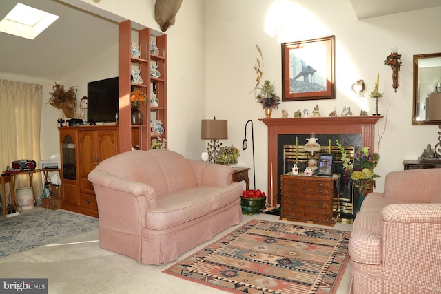 carpeted living area featuring vaulted ceiling with skylight