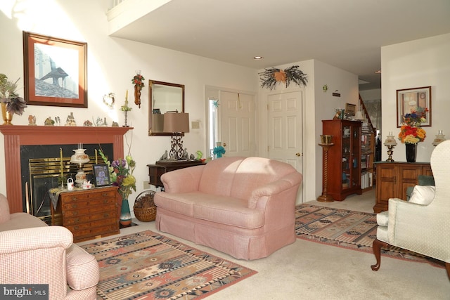 living room featuring a fireplace and carpet flooring