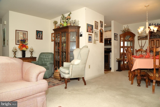 carpeted living area with a chandelier