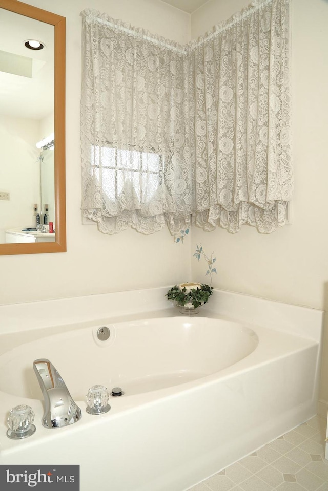 full bathroom with a bath and tile patterned floors