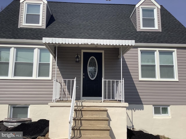 property entrance with roof with shingles