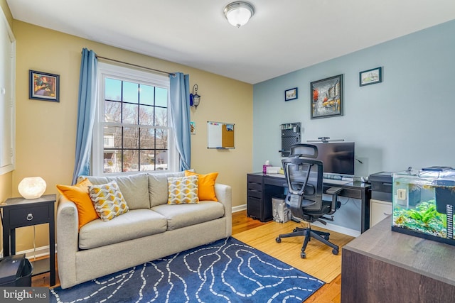 office space with wood finished floors and baseboards