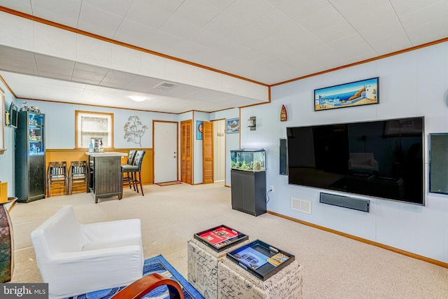 living area featuring carpet floors, visible vents, and ornamental molding