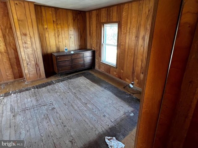 miscellaneous room featuring hardwood / wood-style flooring and wooden walls