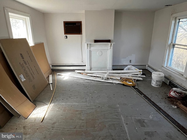 unfurnished living room with a wall mounted AC and baseboard heating